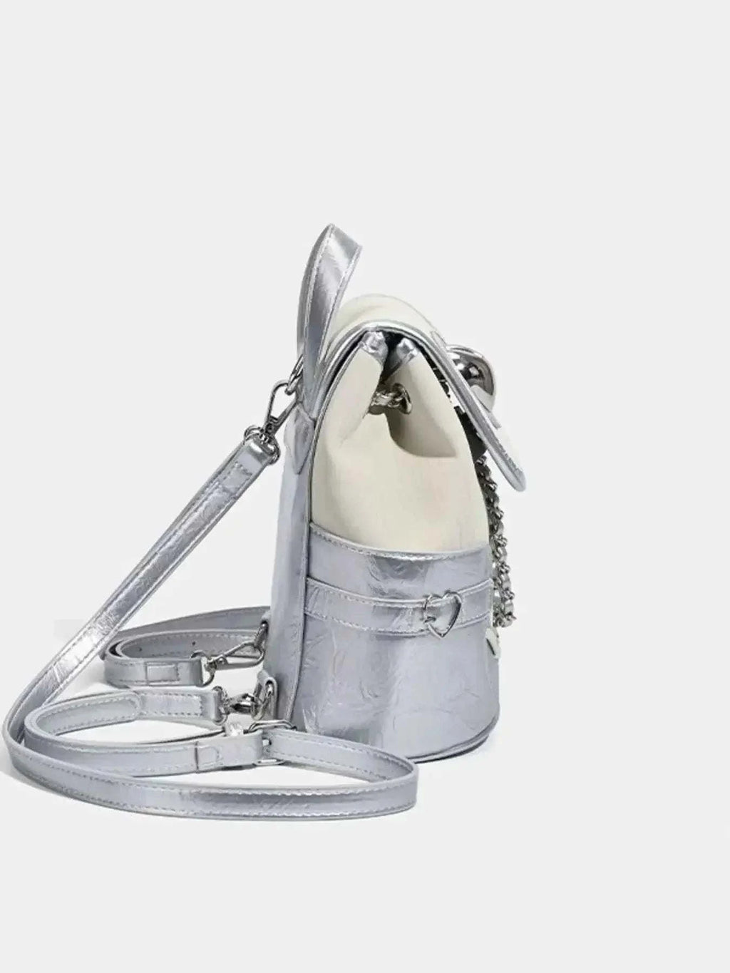 Heart Flap Backpack in silver PU leather with a metallic finish, heart-shaped flap, and adjustable shoulder straps.