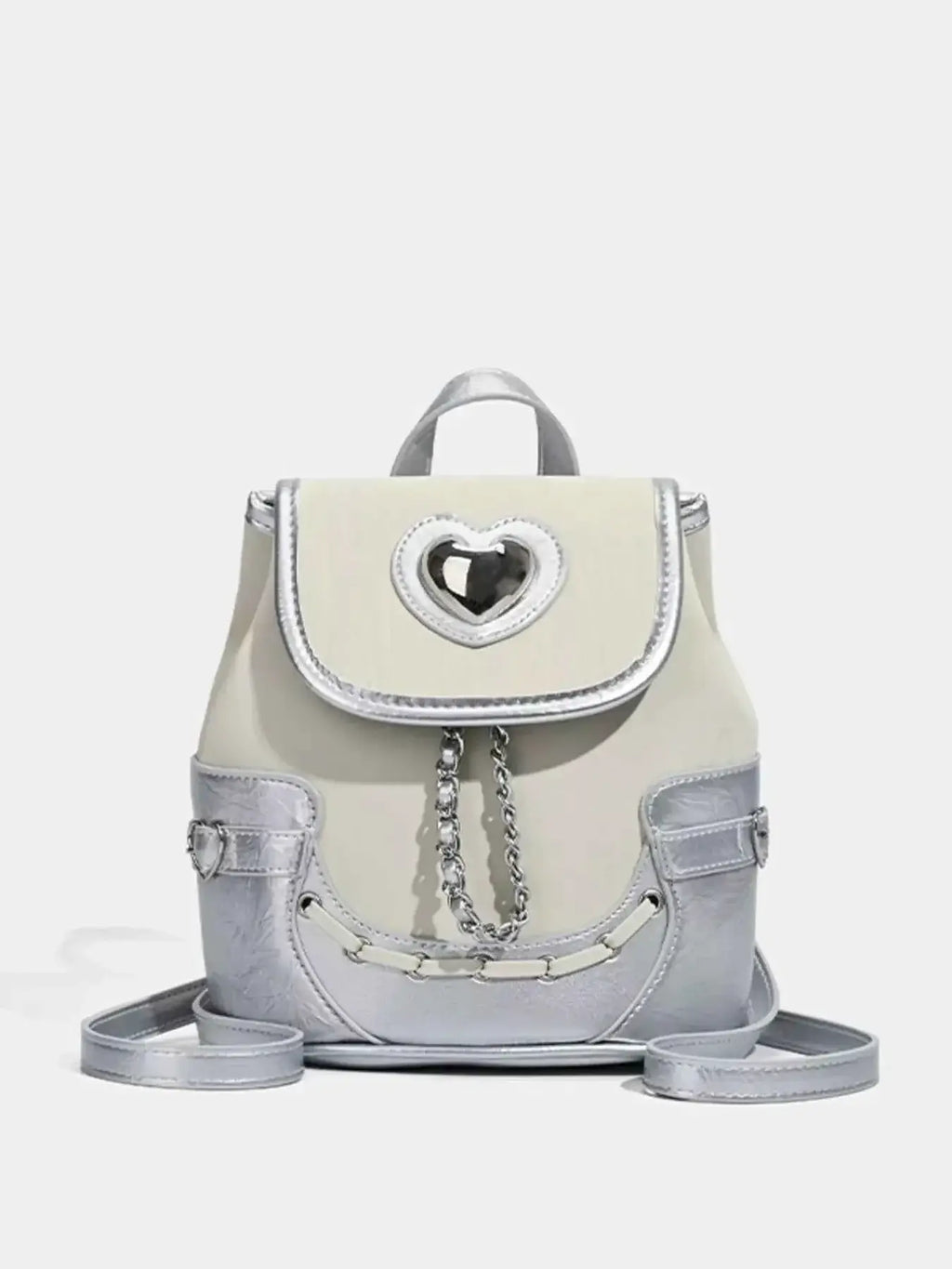 Heart Flap Backpack in silver and cream PU leather with a heart-shaped cutout on the flap and chain detail on the front.