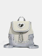 Heart Flap Backpack in silver and cream PU leather with a heart-shaped cutout on the flap and chain detail on the front.