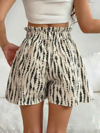 High-Waisted Leopard Print Shorts in beige with black abstract leopard spots and paperbag waist with drawstring detail