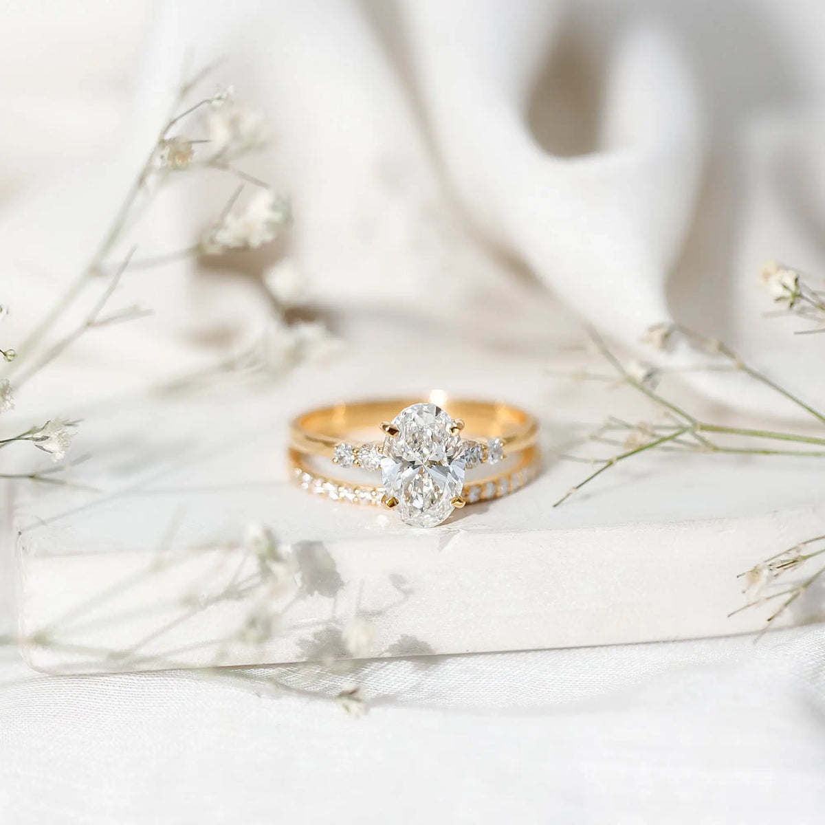 IGI Certified Diamond 3 carat oval cut lab grown diamond engagement ring set in yellow gold with round brilliant side stones