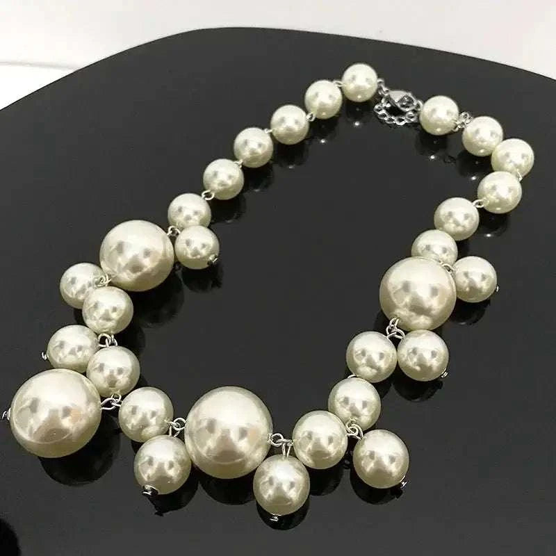 Imitation Pearl Women's Necklace featuring large and small round ivory-colored beads with silver-tone metal links and clasp
