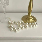 Imitation Pearl Women's Necklace with large and small round white beads arranged as a choker with a silver clasp
