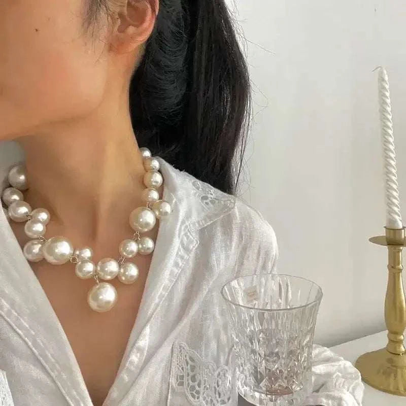 Imitation Pearl Women's Necklace featuring large, shiny white round beads arranged in a choker style with varied sizes