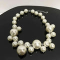 Imitation Pearl Women's Necklace featuring large and small shiny white simulated pearls in a chic choker style with silver links
