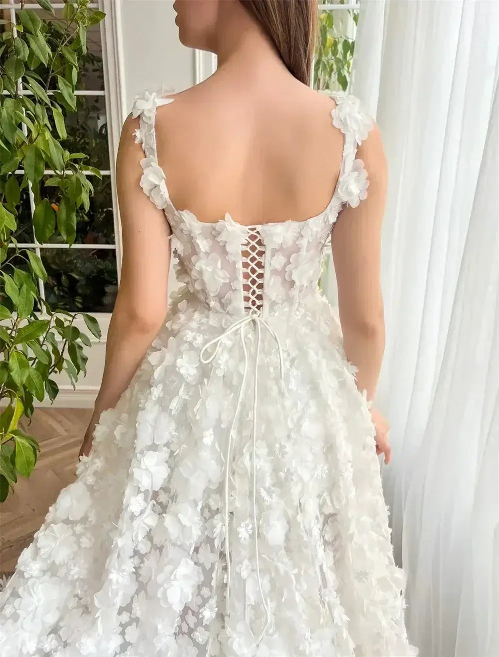 Kyoto Beige Wedding Dress featuring a backless lace-up design with delicate 3D flower appliques on a flowy skirt