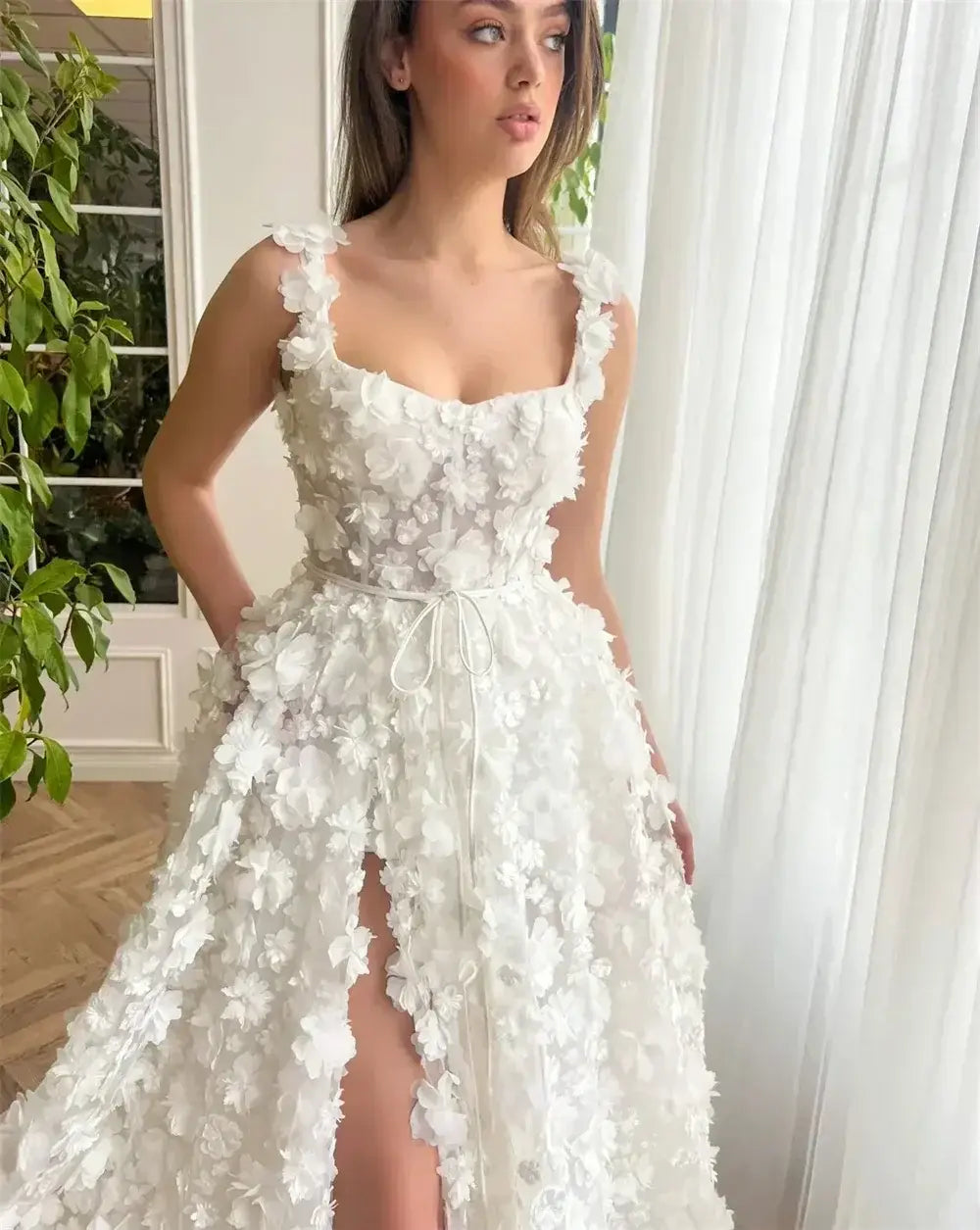 Kyoto Beige Wedding Dress featuring white 3D floral appliques, sleeveless with straps and a front slit on a floor-length skirt