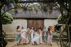 Kyoto Customized Lace wedding dress with floral lace pattern worn by bride surrounded by bridesmaids in pastel dresses under hanging wisteria