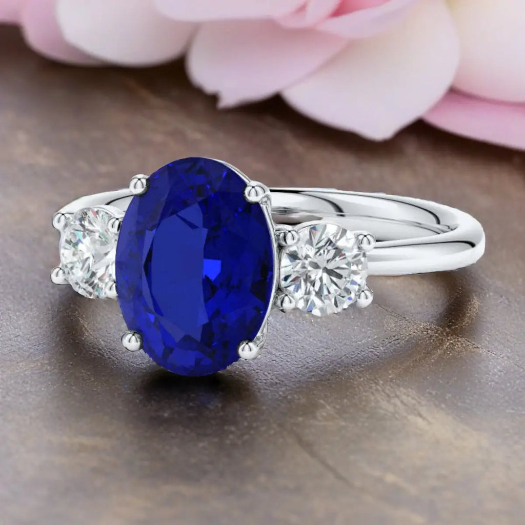 Lab-Grown Blue Sapphire oval deep blue center stone engagement ring with two round lab-grown diamonds set in polished 14K white gold