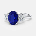 Lab-Grown Blue Sapphire oval-cut blue sapphire center stone with two round brilliant diamonds set in polished 14K white gold