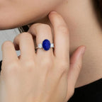 Lab-Grown Blue Sapphire ring with deep blue oval center stone, flanked by round diamonds set in polished white gold band