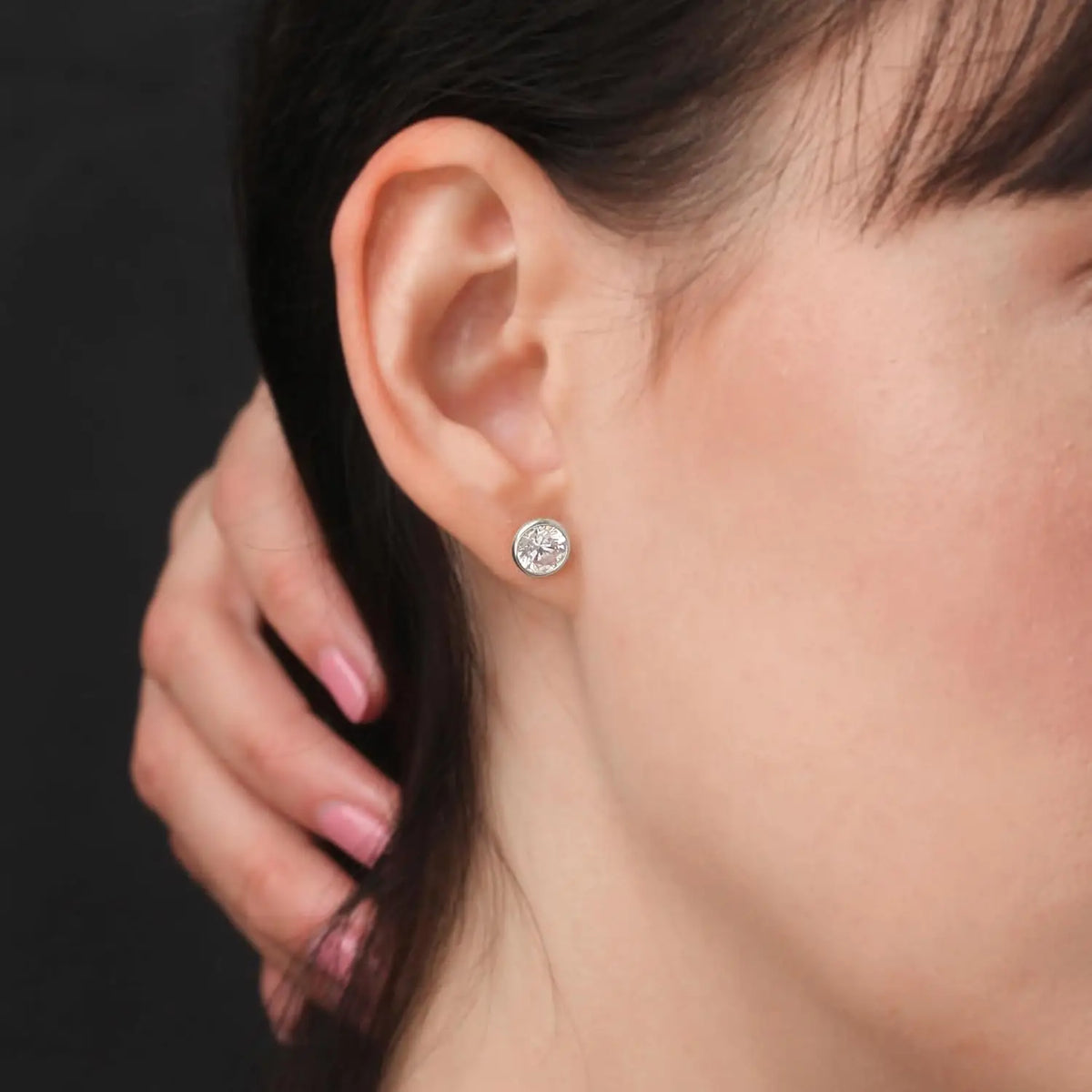 Lab grown diamond bezel stud earring in 14K white gold featuring a round brilliant cut with high clarity and sparkle