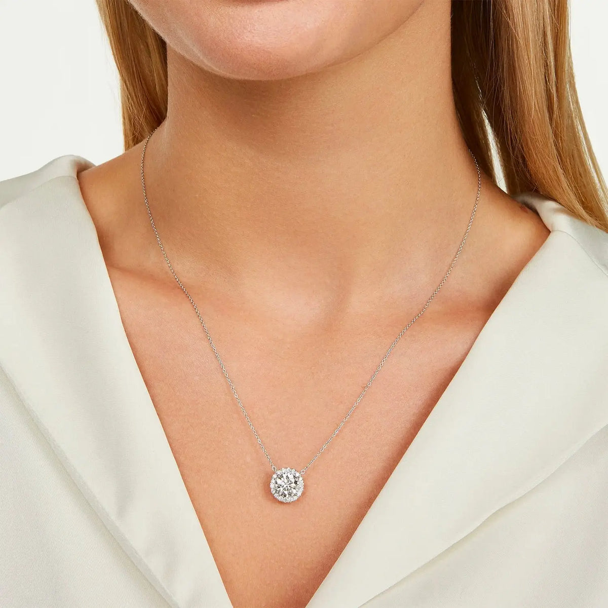 Lab-Grown Diamond Halo Pendant featuring a round brilliant-cut center diamond with a halo of smaller diamonds on a 14kt white gold chain