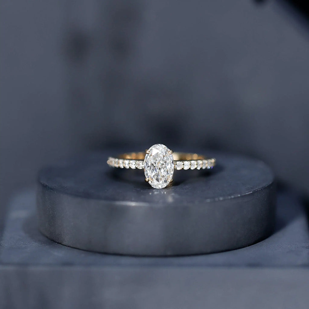 Lab Grown Diamond oval cut engagement ring with small diamond accents on gold band in prong setting