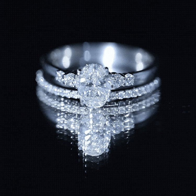 Lab Grown Diamond engagement ring set with a sparkling oval center stone and round side stones in silver metal
