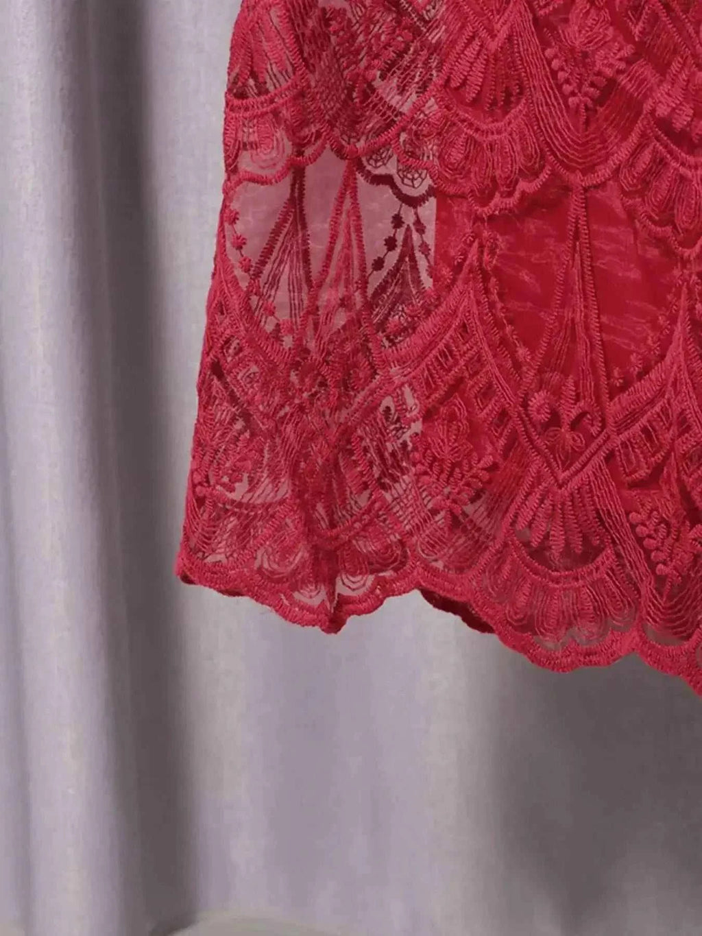 Red lace detailing on a Lace Button Front Midi Dress showing intricate floral and geometric patterns on sheer fabric