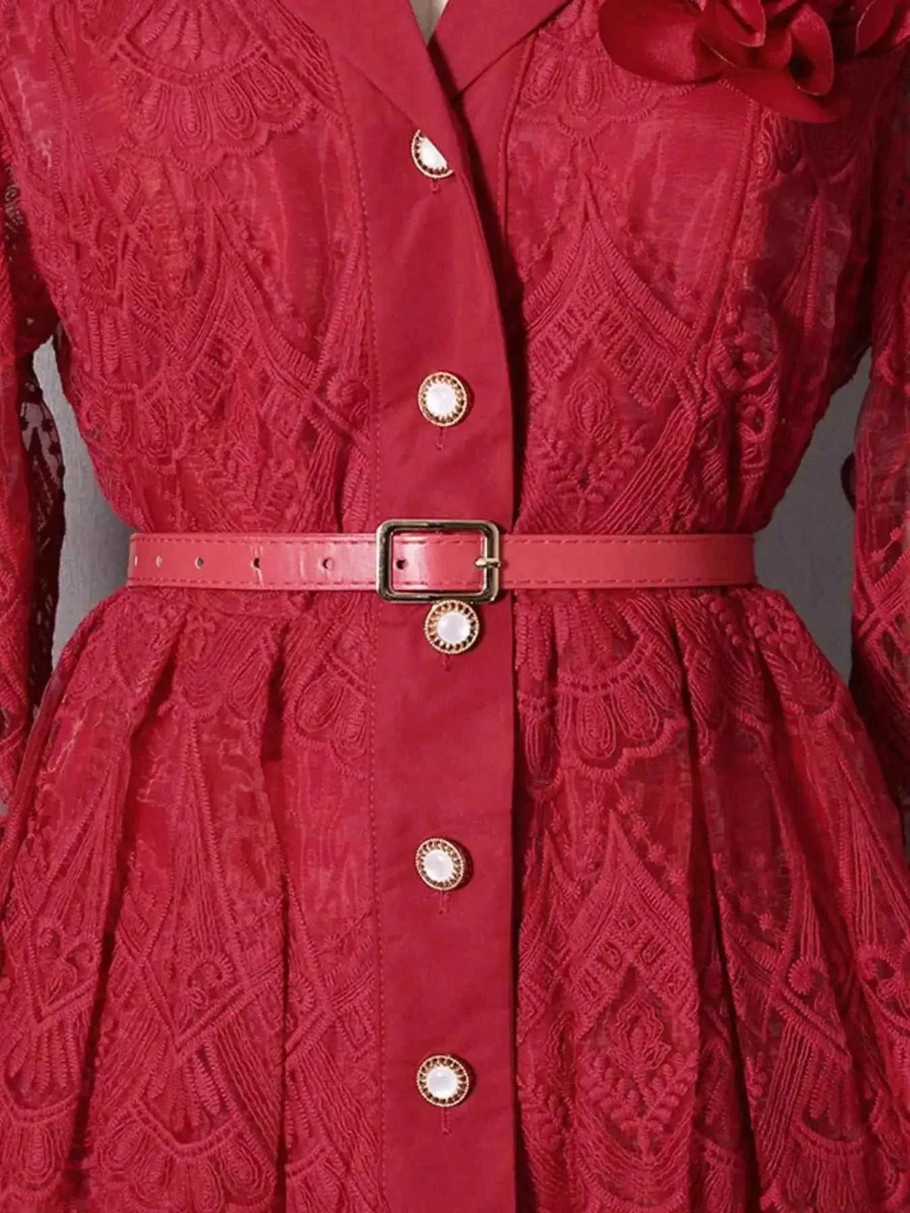 Red lace button front midi dress with intricate floral patterns, pearl buttons, and a matching pink belt at the waist