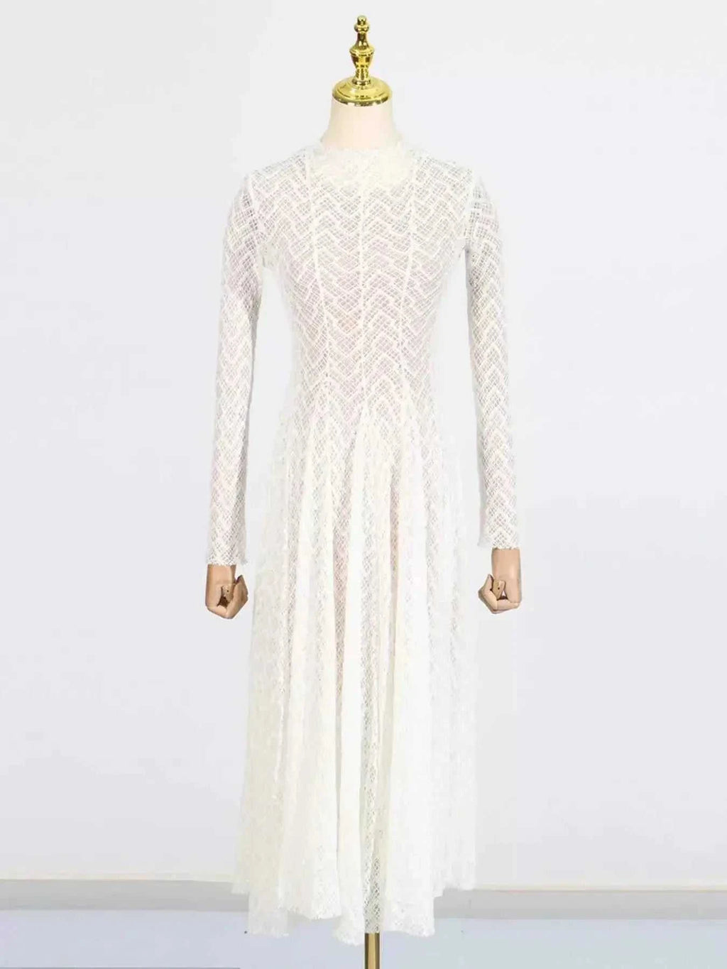 White lace mock neck long sleeve maxi dress with geometric pattern and fitted bodice on mannequin