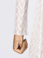 Lace Mock Neck long sleeve maxi dress in white lace fabric with diamond pattern on a mannequin hand