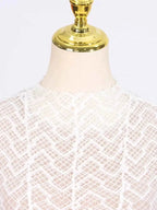 Lace Mock Neck white long sleeve maxi dress with intricate geometric lace pattern and lined bodice on mannequin