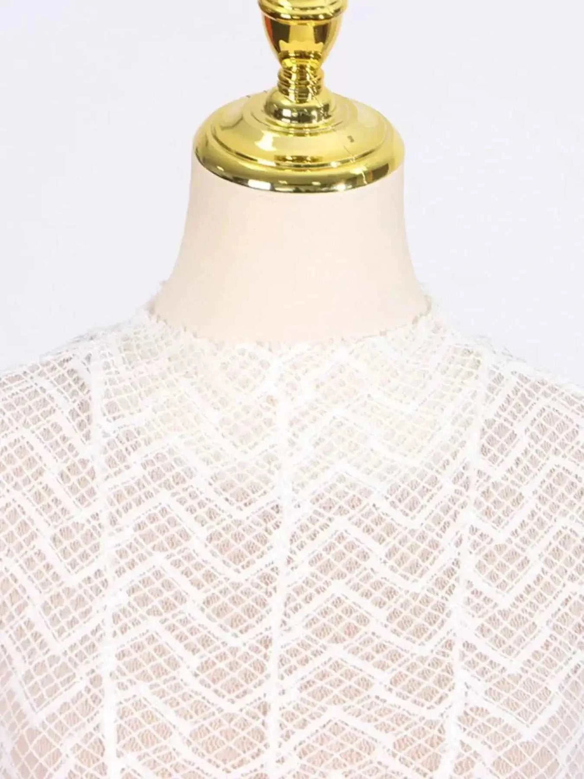 Lace Mock Neck white long sleeve maxi dress with intricate geometric lace pattern and lined bodice on mannequin