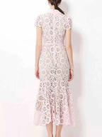 Lace Short Sleeve Midi Dress in light pink with floral lace pattern, short sleeves, back zipper, and fitted waist