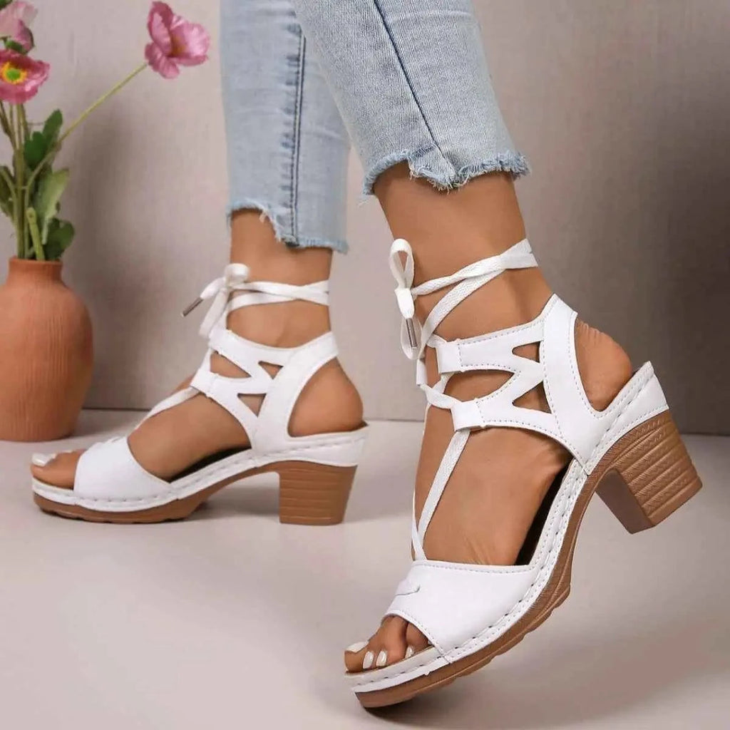 White PU leather Lace-Up Block Heel Sandals with mid-height block heels and ankle tie straps on model feet