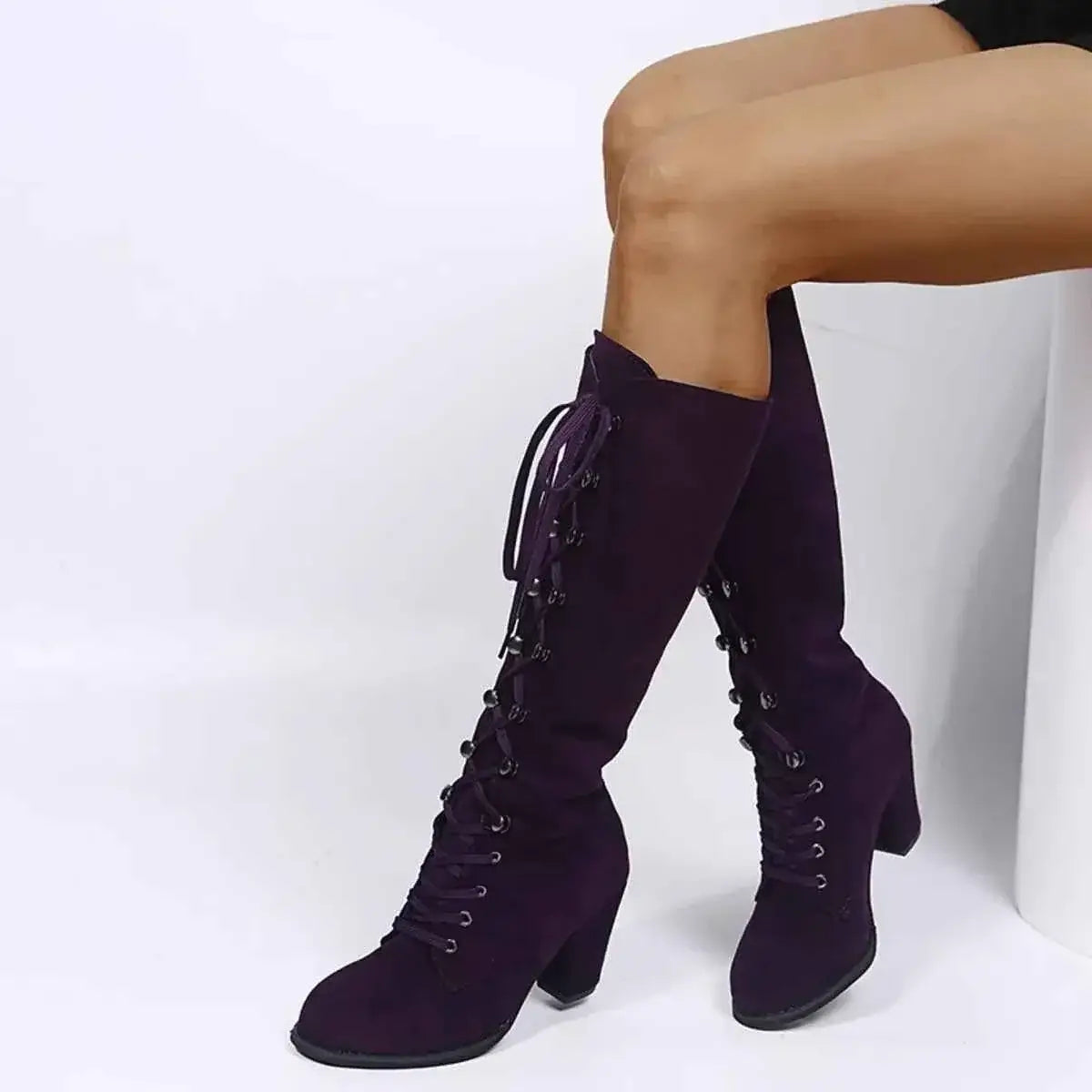 Purple suede knee-high boots with lace-up front and block heels, featuring rubber soles and a sleek silhouette, Lace Up Block Heels style.