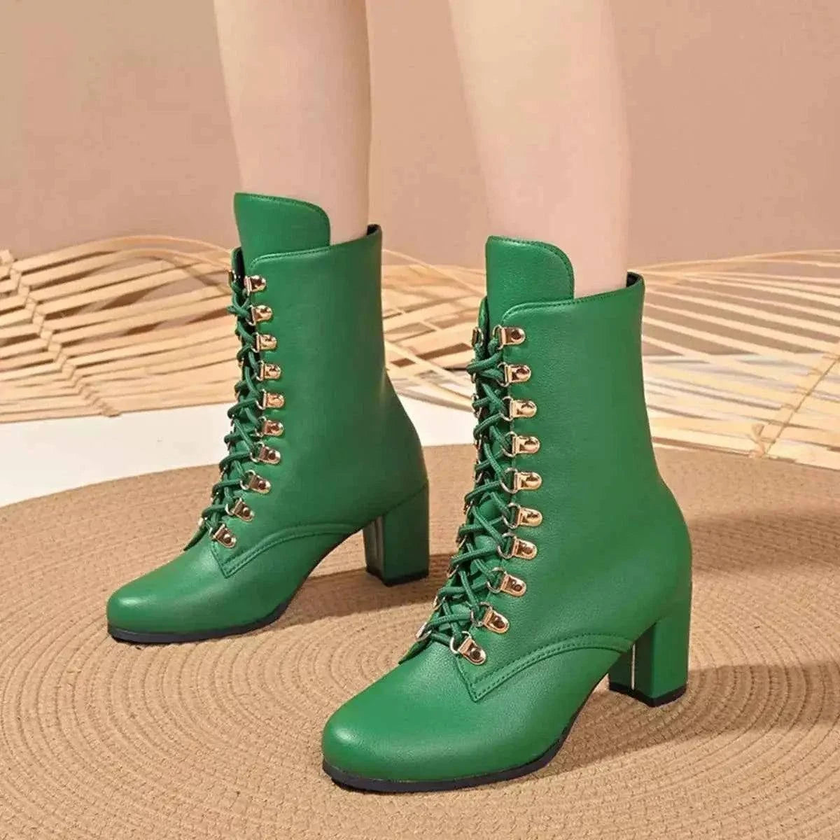 Green PU leather Lace-Up Boots with gold eyelets and block mid heels, featuring rubber soles and a sleek design.