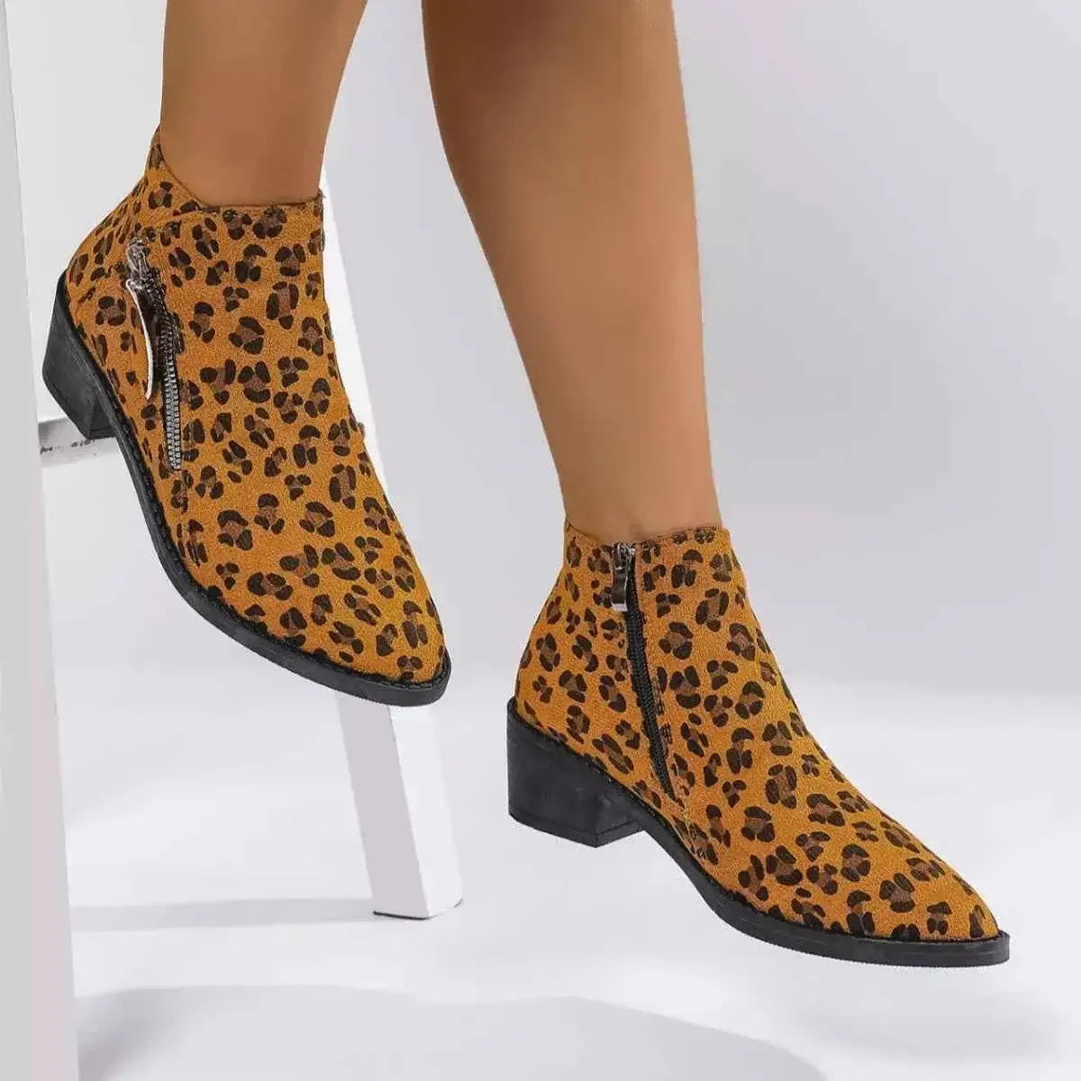 Leopard Block Heel ankle boots in tan suede with black leopard spots, side zipper, and black rubber block heels