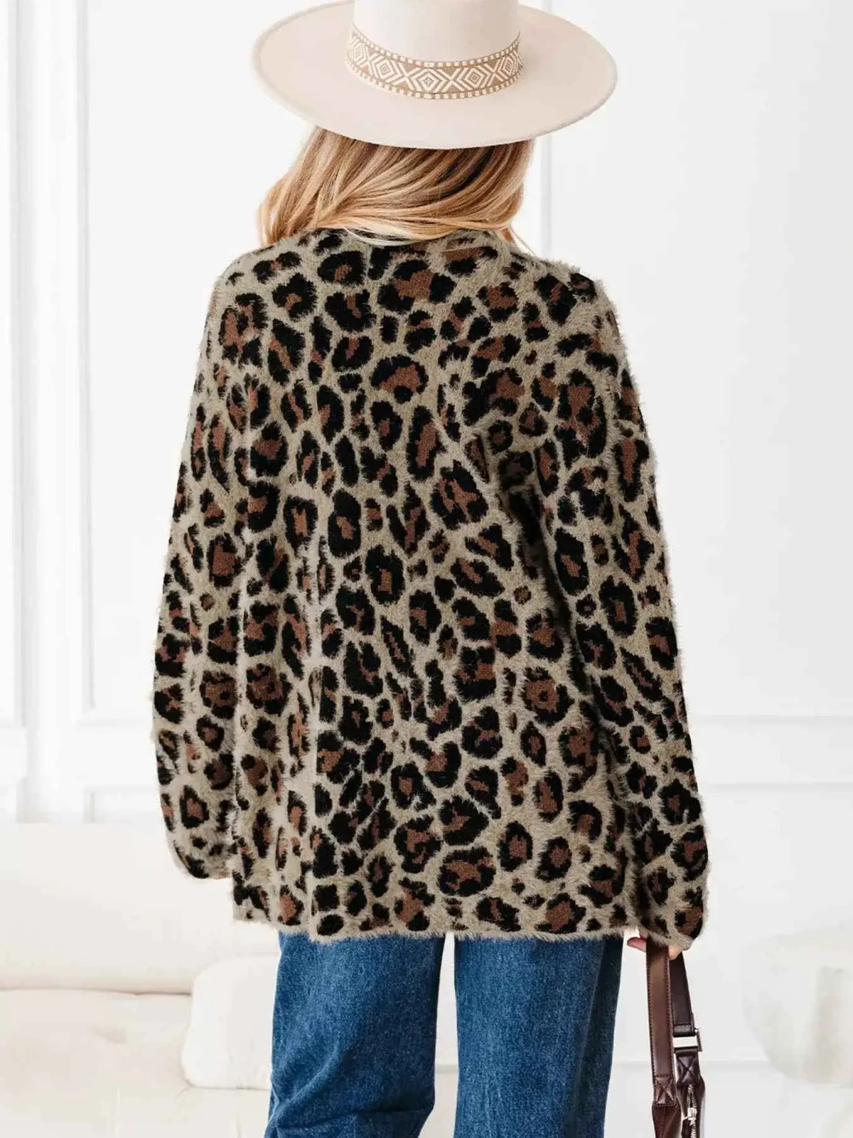 Leopard Open Casual Cardigan in brown and black animal print pattern, long sleeves, and a relaxed fit worn with blue jeans