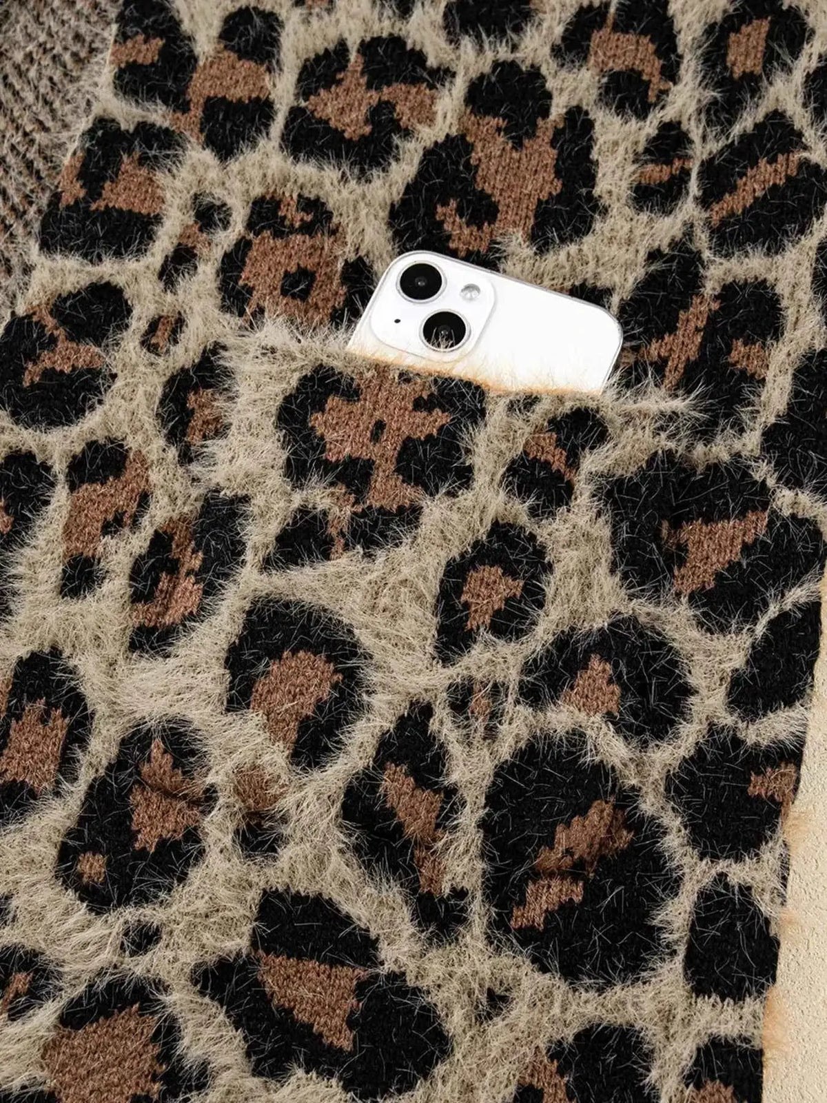 Leopard Open Casual Cardigan featuring a fuzzy texture in brown, beige, and black leopard print with a pocket holding a white smartphone