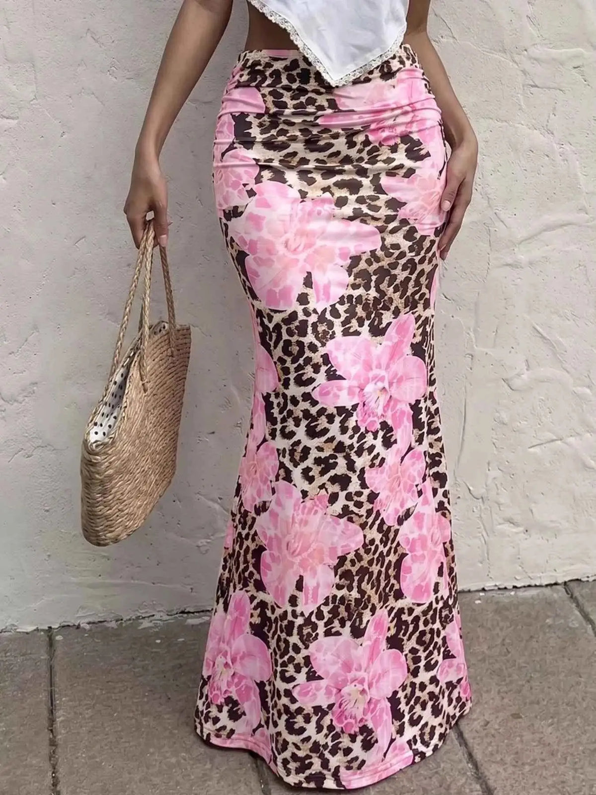 Leopard Print Bodycon maxi skirt featuring a brown and black leopard pattern with large pink floral accents and a fitted silhouette