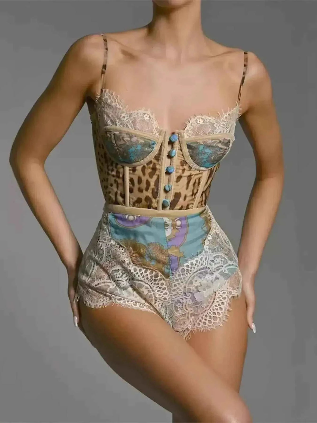 Leopard Print Lace romper with leopard pattern, lace trim, blue buttons, and patchwork floral design on shorts