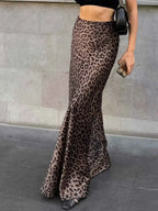 Leopard Print Maxi Skirt in brown and black polyester with a fitted high waist and flared hem worn by a slim model