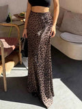 Leopard Print Maxi Skirt with brown and black leopard spots, made of flowy polyester, worn with a black crop top.