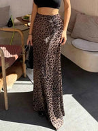 Leopard Print Maxi Skirt with brown and black leopard spots, made of flowy polyester, worn with a black crop top.