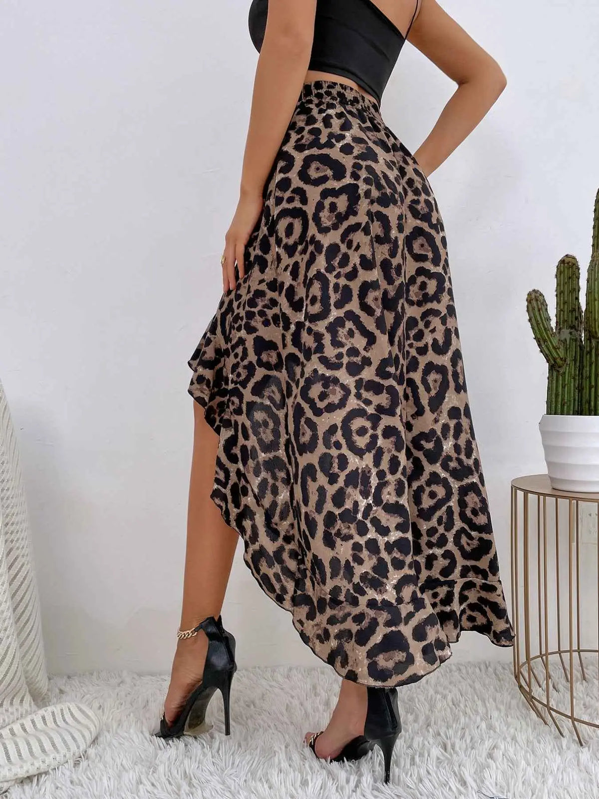 Leopard Print Ruffle Hem high-low skirt in brown and black polyester with asymmetrical hem worn with black heels