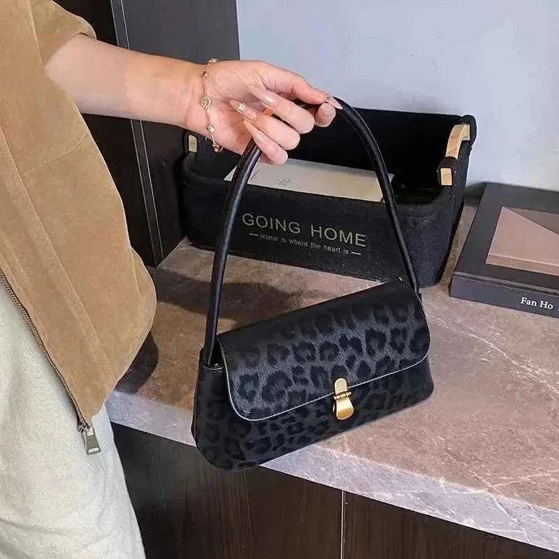 Leopard Print Shoulder Bag in black suede with dark leopard pattern, small size, single strap, and gold clasp closure
