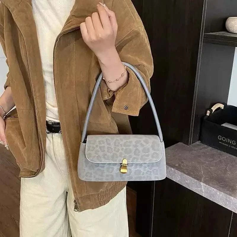 Leopard Print Shoulder Bag in light gray suede with subtle leopard spots, small rectangular shape and gold-tone clasp