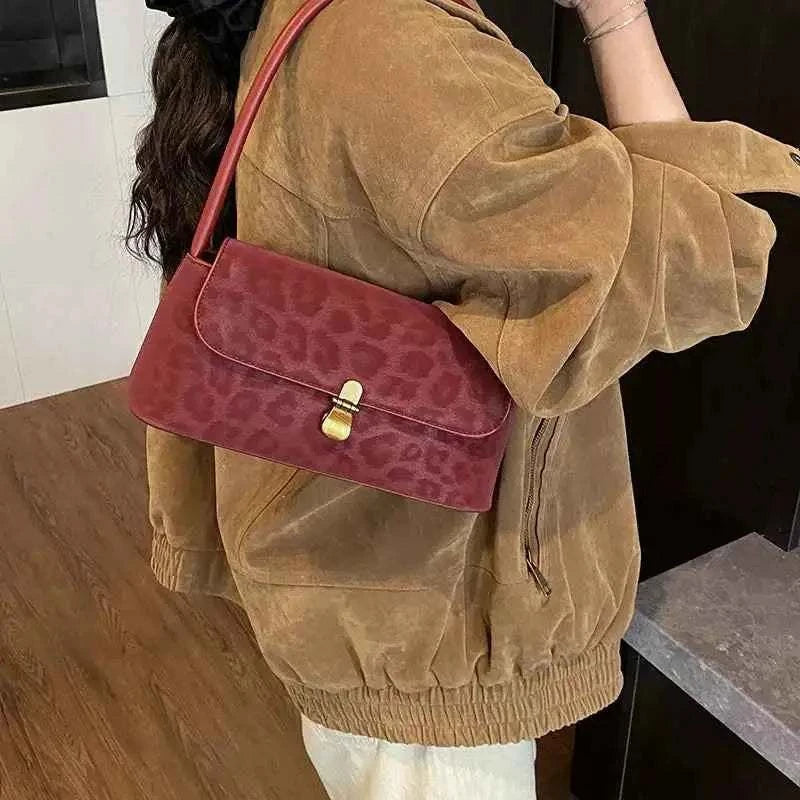 Leopard Print Shoulder Bag in small size with red suede material and subtle embossed leopard pattern featuring a gold clasp
