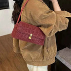 Leopard Print Shoulder Bag in small size with red suede material and subtle embossed leopard pattern featuring a gold clasp
