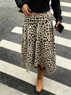 Leopard Print Skirt with asymmetrical hem in beige polyester featuring black spotted pattern and ruched detailing