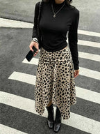 Leopard Print Skirt midi with asymmetrical hem in beige with black spots, ruched detailing, worn with black top and boots
