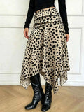 Leopard Print Skirt in beige with black spots, featuring a ruched waistband and asymmetrical hem, made of polyester