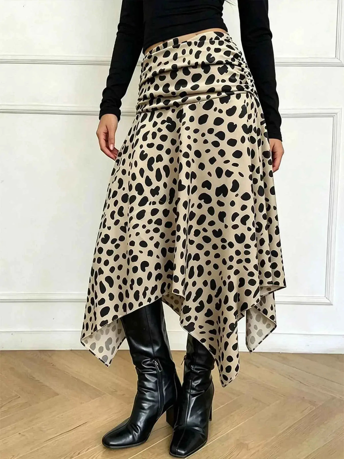 Leopard Print Skirt in beige with black spots, featuring a ruched waistband and asymmetrical hem, made of polyester