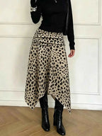 Leopard Print Skirt in beige with black spots, asymmetrical hem and ruched detailing, worn with black boots and top