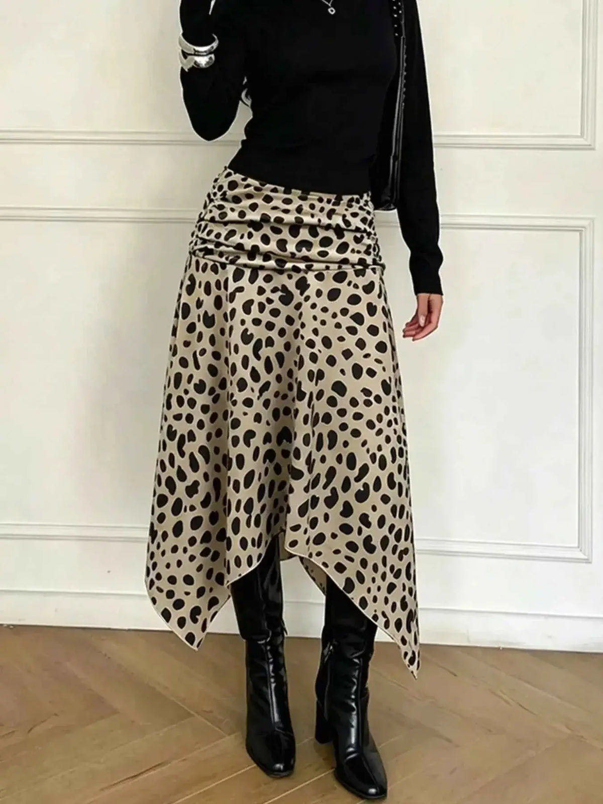 Leopard Print Skirt in beige with black spots, asymmetrical hem and ruched detailing, worn with black boots and top
