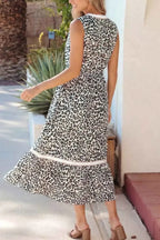 Leopard Print sleeveless midi dress with colorblock trim and tiered skirt in black and white polyester fabric