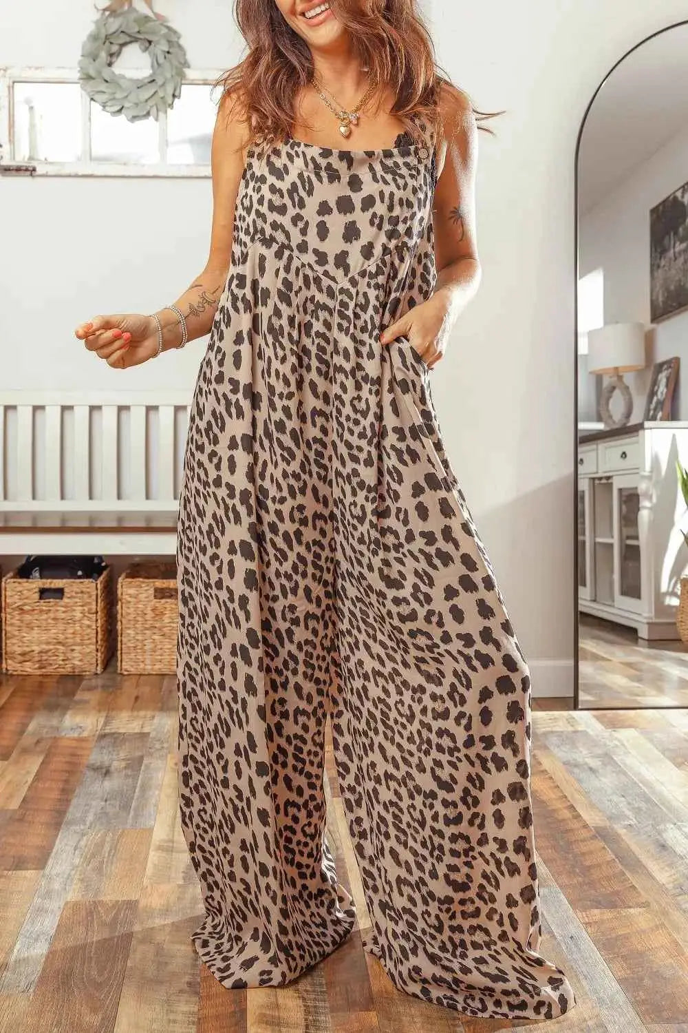 Leopard Print sleeveless jumpsuit with square neck, pleated wide legs, and side pockets in brown and black tones